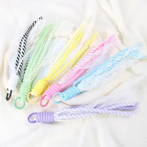 Colorful lace braided phone charm detail, DIY lanyard strap accessory with pearls and clasp hook.