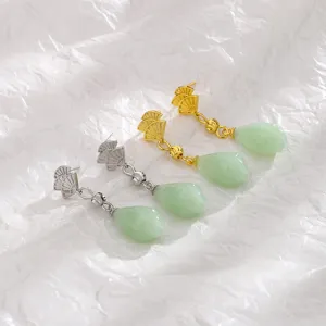 Detailed view of Chinese style fan-shaped earrings with green jade pendants in gold and silver
