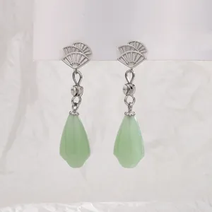 Detail view of Chinese style fan-shaped dangle earrings with light green teardrop pendants