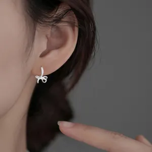 Elegant sparkly bow huggie hoop earrings featuring micro-pave cubic zirconia stones