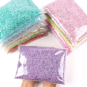 Detailed macro view of colorful ice-clear resin rhinestones in transparent bags.