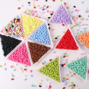 Detailed macro view of colorful peanut-shaped candy color beads in several white trays