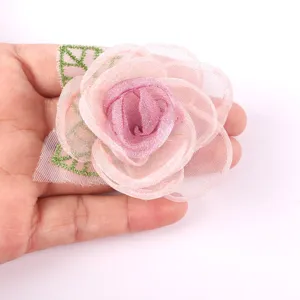 Handmade organza flower detail shot, pink floral applique for DIY crafts and apparel.
