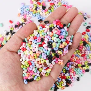 Detailed view of colorful peanut-shaped candy color beads for DIY jewelry making