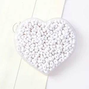 High-quality detailed shot of white peanut-shaped acrylic beads for DIY jewelry making
