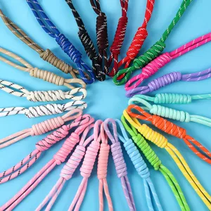 Detail view of various colorful hand-woven paracord lanyards for DIY bag charms and phone chains