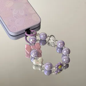Detailed view of purple macaron acrylic beads phone strap with pink bow and heart charms