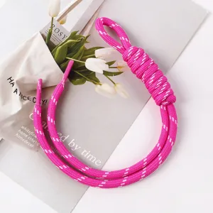 Detailed macro view of handcrafted pink woven rope bag charm accessory for phone or keys