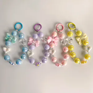 Detail view of colorful macaron acrylic phone chains with heart and bow charms