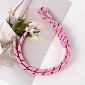 Detailed macro of a pink braided rope bag charm featuring a unique hand-tied loop knot
