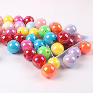 Detailed view of various colorful shiny AB acrylic round beads for DIY jewelry making.
