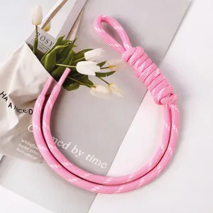 Close-up of pink manual braided rope charm for DIY bag and phone accessories.