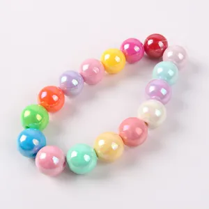 Detailed view of colorful iridescent macaron acrylic beads for DIY jewelry making projects.