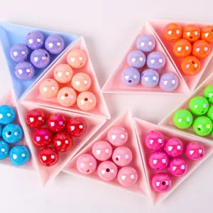 Close-up of colorful macaron acrylic AB round beads sorted in trays for DIY jewelry