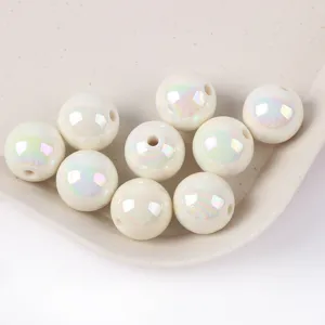 Close-up of pearlescent AB acrylic round beads for DIY jewelry making with rainbow sheen.