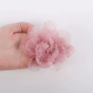 Handmade pink chiffon flower accessory for DIY hair crafts and garment decoration.