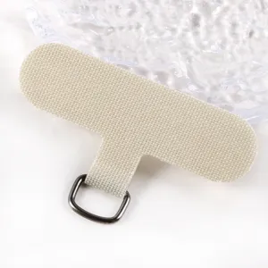 Close-up detail of a universal fabric phone tether tab with metal D-ring in beige.