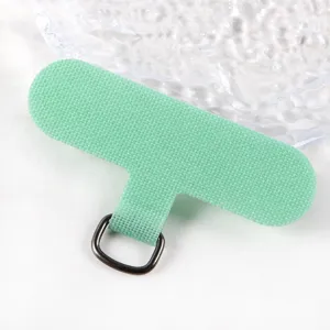 Close-up detail of green phone lanyard tether tab with metal ring, durable TPU material.