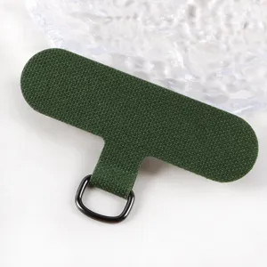 Detailed view of dark green canvas phone lanyard tether patch with metal D-ring for phone case.