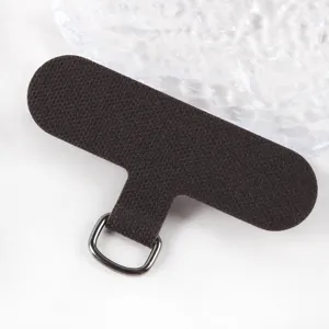 Detailed view of dark brown phone lanyard tether tab with metal D-ring for phone cases.