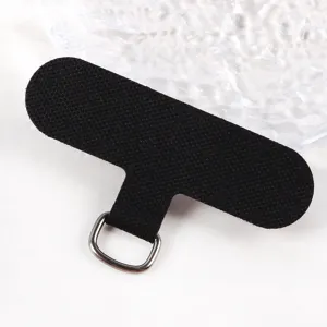 Universal phone lanyard tether tab, black fabric patch with metal D-ring for phone cases.