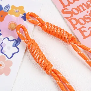 Detailed view of the orange braided nylon rope charm for phone and bag accessories