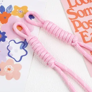 Close-up view of pink braided nylon rope pendant with decorative woven spiral detail