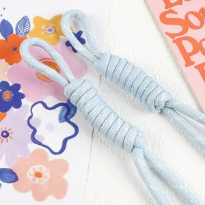 Detailed macro shot of light blue woven nylon cord pendant for phone or bag accessories