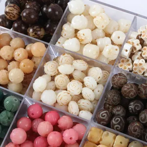 Detailed view of colorful carved DIY loose beads, floral and cat shapes for bracelets.