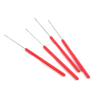 Detail shot of precision beading needles and latch hooks with red handles for DIY threading tasks.