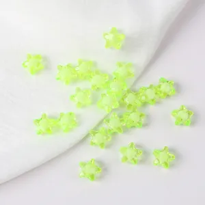 Macro detail view of 11mm neon green acrylic star beads for creative DIY jewelry making.