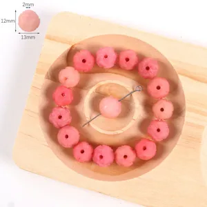 Pink carved lotus bodhi beads detail view showing fine floral engraving and dimensions.