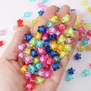 Hand holding colorful 11mm acrylic star beads for DIY jewelry making accessories.