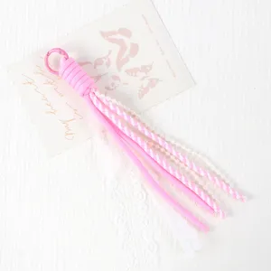 Pink paracord phone charm with pearl beads and white lace sweet style strap accessory.