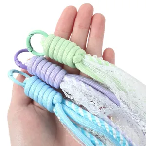 Colorful braided paracord phone lanyard with delicate lace and pearls, DIY wrist strap charm.