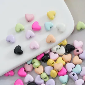 Detailed closeup of colorful alloy heart beads, perfect for DIY phone charms and necklaces.