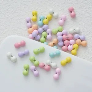 Close-up view of colorful peanut-shaped DIY craft beads, ideal for custom accessories and jewelry.