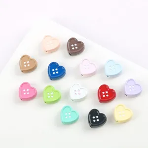 Close-up view of colorful heart shaped alloy button beads for DIY jewelry crafts.
