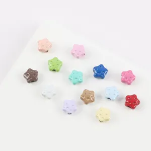 Colorful alloy star beads detail shot, dotted texture, perfect for DIY jewelry making and keychains.