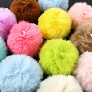 Colorful faux fur pom poms detail shot, fluffy rabbit hair balls for DIY jewelry and crafts.