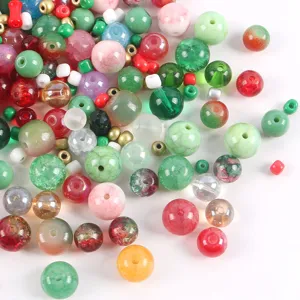 Detailed macro view of various colorful mixed glass beads for DIY jewelry making.