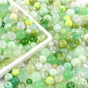 Close-up macro view of 20g mixed green glass beads with diverse textures for DIY jewelry