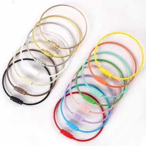 Detailed view of colorful coated steel wire keychain loops, flexible metal rings with screw locks.