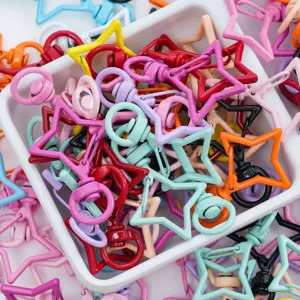 Vue détaillée d'une variété de mousquetons en alliage colorés en forme d'étoile pour le DIY