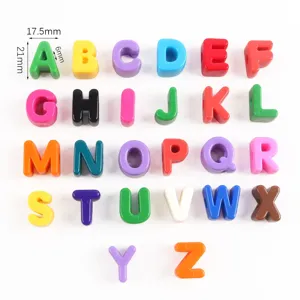 Detailed macro view of 26 colorful acrylic alphabet beads showing 21mm height measurements