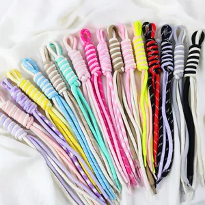 Macro detail of colorful braided nylon cords with double-strand DIY accessory design.