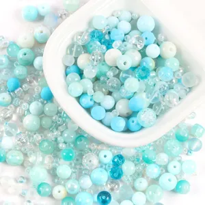 Close-up macro view of mixed blue and white glass beads for DIY jewelry making crafts