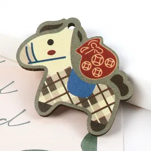 Detailed view of a colorful wooden horse charm with traditional fortune bag design