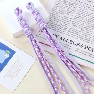 Detail showing the intricate texture of hand-woven lavender and white nylon rope charms