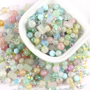 Macro view of assorted pastel glass beads in various shapes for jewelry making